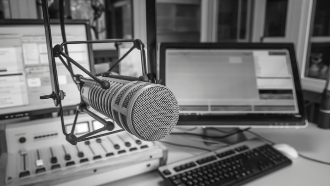 Melnbalts attēls, tuvplānā redzams mikrofons radio studijā