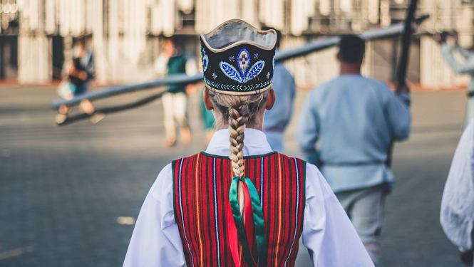 Tautas deju dejotāja stāv ar muguru