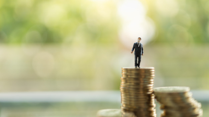 Attēlā redzamas monētas un cilvēka miniatūra