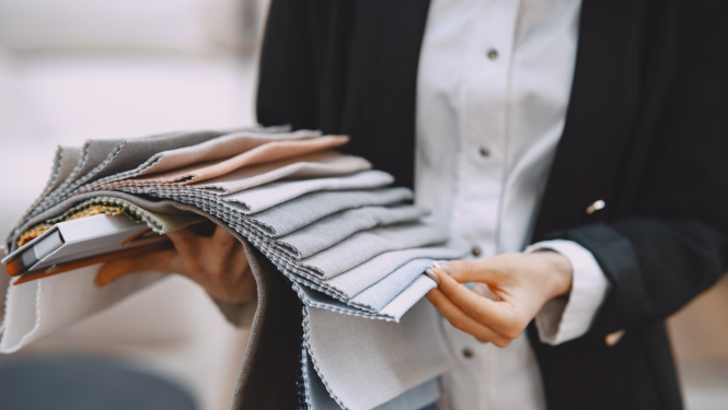 Pārdevēja rāda auduma paraugus